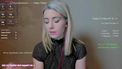 Video of a young woman with long blonde hair, wearing a black lace top, seated against a plain background. Text overlays show video statistics and social media links.