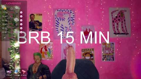 Video of a man's erect penis in front of a pink wall adorned with colorful pop art posters, overlaid with text \"BBR 15 MIN\" in white.