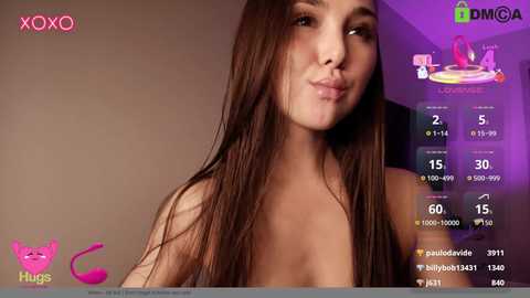 Video of a nude Asian woman with long brown hair, light skin, and small breasts, smiling, in a studio setting.