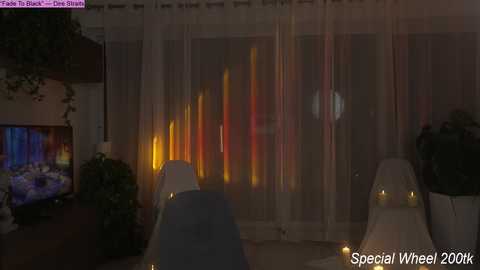 Video of a dimly lit, modern living room with a TV, plants, and a Christmas tree in the background, featuring \"Take a Shot of The Ship\" text in the top left corner and \"Special Wheel 2004\" in the bottom right.