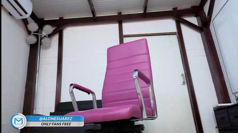 Video of a modern, pink reclining chair with silver armrests in a white-walled, wooden-framed room with an air conditioner and small lamp. Text at the bottom reads \"@alonsojerez\" and \"Only fans free.\