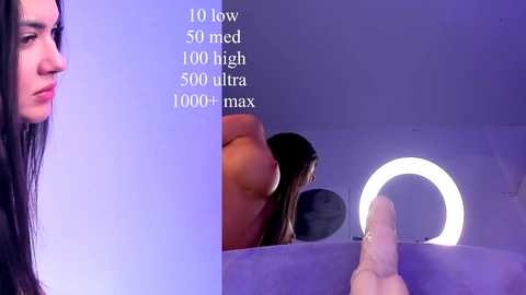 Video of a nude woman with long black hair, standing in a dimly lit, modern bathroom with a glowing circular light and a mirror reflecting her partially visible body. Text overlays stats about the bathroom's size and lighting.