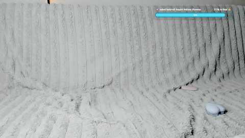 Media: A video of a snowy, icy landscape with a dark, rocky outcrop in the foreground and a blue sky in the background.