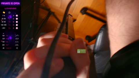 Video of a close-up view of a person's hand holding a green and yellow USB stick, with a purple screen displaying private mode settings in the background.