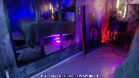 Video of a dimly-lit, Gothic-style bedroom with a large mirror, candles, and a bed covered in a dark sheet. The walls are adorned with purple and blue lighting, creating a mysterious atmosphere.