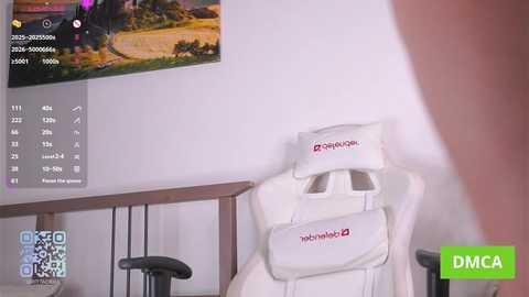 Video of a gaming setup: a white chair with \"ahoy\" logo, desk with black chair, monitor displaying a tropical beach scene, and a DMC logo in the corner.