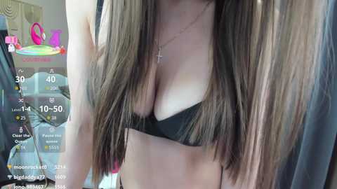 A video of a young woman with long, straight brown hair, wearing a black bra, taken in a bedroom setting, with a smartphone's virtual reality interface overlay.