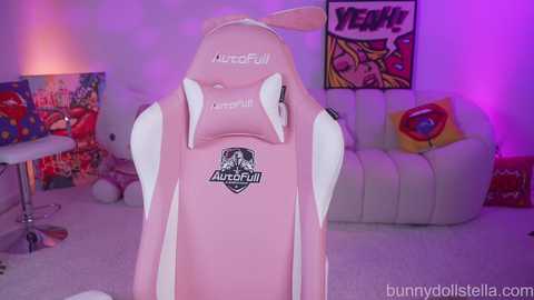 Video of a pink gaming chair with \"AutoFul\" branding, in a colorful, cozy room with plush toys, a white sofa, and vibrant posters.