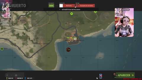 Screenshot of a tactical video game map with green, brown, and blue tones. Inset: a live video feed of a woman in a black top, wearing a headset, playing the game.