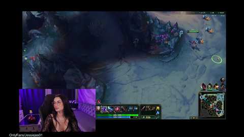 A video of a live-streamer with long hair, wearing glasses, and a black top, playing League of Legends. The background shows a detailed map with various characters and a dark, mysterious atmosphere.