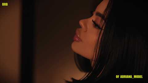 Video of a close-up profile shot of a young woman with long, dark hair, smooth olive skin, and full lips, in dim lighting, with text overlay reading \"Of Adelina Model.\