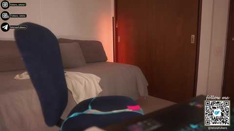 A video shows a bedroom with a gray couch, a white blanket, a wooden door, and a pillow with a blue cover. A QR code and social media icons are visible in the bottom right.