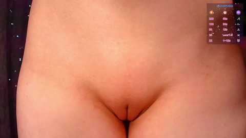 A close-up video of a nude person's pubic area, focusing on the genital region. The background includes a dark, starry pattern and a digital clock displaying the time.