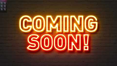 A video of a neon sign on a brick wall that reads \"COMING SOON!\" in bright red and yellow letters, with a dimly lit, urban background.