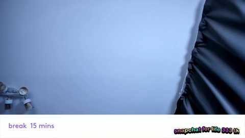 A video of a foggy road with a blurred car in the distance and a shadowy figure in the foreground, captioned \"break 15 mins.\