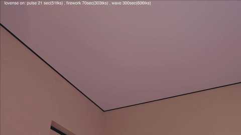 A video of a ceiling corner with a pale pinkish-gray hue, featuring a thin, black trim line outlining the edge. The background wall is a light beige color.