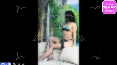 A blurred video of a woman in black lingerie and stockings, sitting on a cream couch with lush green foliage in the background.