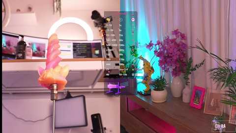 A video of a vibrant, modern living room with a bright pink, swirled unicorn lamp, purple orchids, and a wooden desk adorned with decorative items.