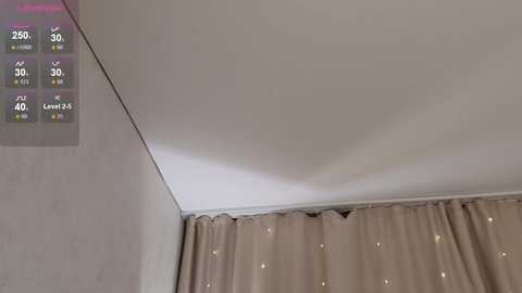 Video of a ceiling with a noticeable dip in the middle, beige curtains with subtle patterns, and a digital display showing temperature, humidity, and air quality levels.