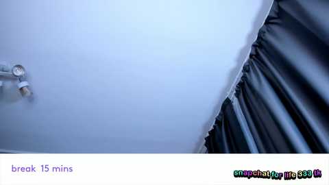 Video of a ceiling with a crack, showing a man in a gray shirt and black pants standing near the break, looking up.