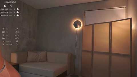 Video of a minimalist, modern living room with a beige sectional sofa, a cylindrical floor lamp, and frosted glass sliding doors, featuring a digital interface displaying room temperature, humidity, and lighting settings.