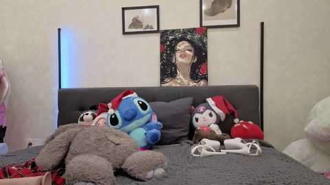 Video of a cozy bedroom with a plush bed, featuring plush toys, a Christmas tree, and a framed photo of a woman with long black hair.
