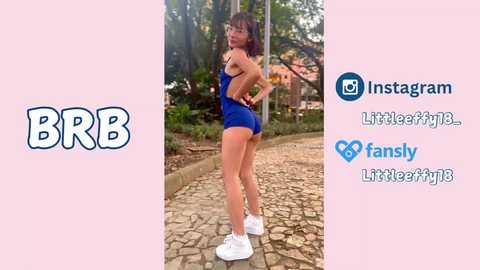 Video of a young woman with medium-length brown hair, wearing a blue one-piece swimsuit and white sneakers, posing outdoors on a cobblestone path surrounded by trees. Social media icons overlay the image.