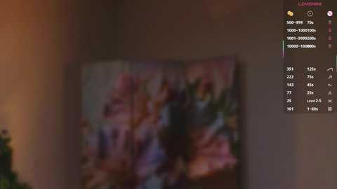 A dimly lit video of a TV showing a blurred anime scene. A chat window on the right displays text and user information.