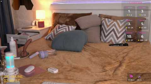 A video of a cozy bedroom with a brown bedspread, a nightstand, a lamp, and a phone; a digital fitness app overlay displays workout stats.