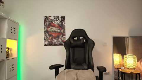 Video of a modern, minimalist gaming room with a black gaming chair, beige blanket, white shelves, red and black \"Metallica\" poster, and lit-up geometric lamps.