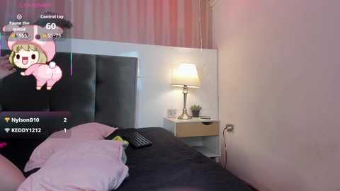 Video of a modern bedroom with a dark bed, pink lamp, and a chibi-style anime girl in a pink bunny costume floating in the top left corner.
