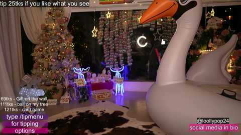 A festive bedroom with a large, inflatable swan, a decorated Christmas tree, and glowing reindeer. Text overlays suggest a social media post.