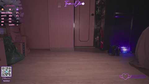 Video of a dimly-lit, pink-themed bedroom with a large, lit Christmas tree on the left, a glowing blue LED device on the floor, and a closed door with a \"Teen-Flirt\" sign.