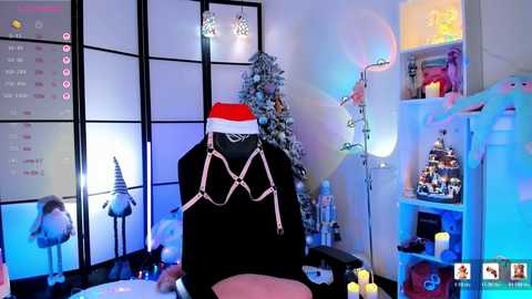 A video of a festive, modern living room with a black leather chair adorned with a red Santa hat, surrounded by holiday decorations including a decorated tree, candles, and a festive arrangement on a white shelf.