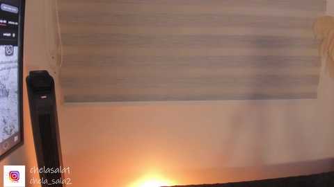 A video of a modern living room ceiling with a recessed light, white wooden beams, and a black air conditioner unit. The lighting casts a warm glow.