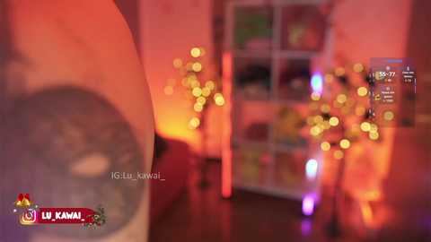 A blurred, warm-toned video shows a cozy, softly lit room with a glass jar of glowing fairy lights and a shelf filled with books and toys. The image is from the LK Kanaal channel, featuring a young boy.