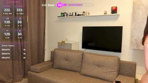 A video of a modern living room with a beige couch, a flat-screen TV on the white wall, and a purple \"Grit Rate\" screen overlay showing sleep stats.