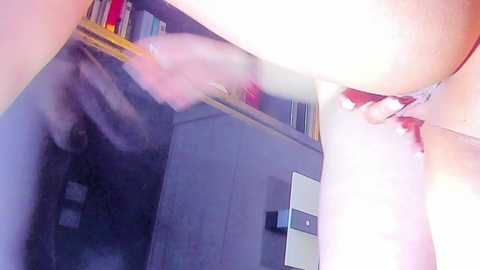 A video showing a close-up of a person wearing red lingerie, with steam and a blurred reflection in a mirror, suggesting an intimate setting.