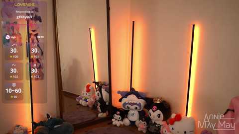 Video of a cozy room with plush toys, a tall floor lamp, and a mirror reflecting the scene, overlaid with a digital interface showing a \"Lorelei\" character.