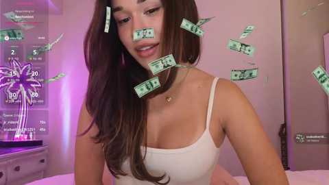 Video of a young Asian woman with long, dark hair wearing a white spaghetti-strap top, surrounded by floating $100 bills in a dimly lit room.