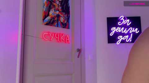 Video of a white door with neon \"CYRKA\" in red, a vibrant abstract painting above, and a neon sign in Cyrillic letters on the wall.