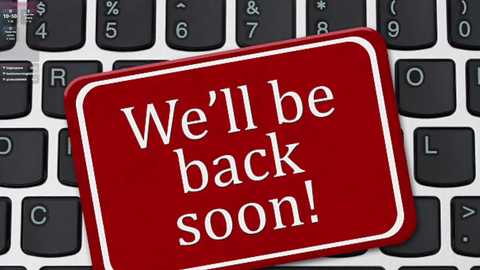 Video of a red sticker with white text \"We'll be back soon!\" placed on a black and white keyboard.