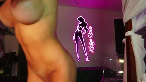 Video of a nude woman with a slender physique, light skin tone, and medium-sized breasts, illuminated by a neon sign reading \"Kage Ryze\" in the background.