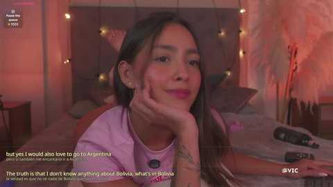 Video of a Latina woman with long dark hair, wearing a purple top, lying on a bed with fairy lights in the background. Text overlay talks about her past relationship with Argentina.