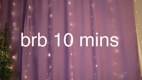 Video of a purple curtain adorned with string lights, with the text \"bbr 10 mins\" overlayed, suggesting a DIY project.