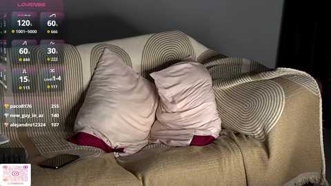 Video of a beige couch with a pink blanket and pillow, displaying a weather app on the left side, showing 60-degree temperature.