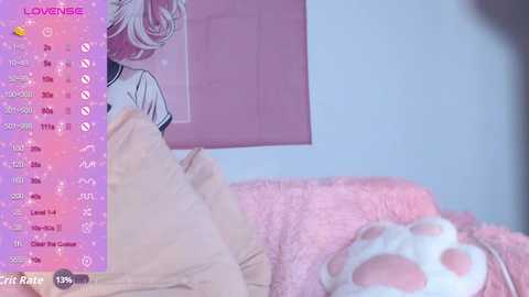 Video of a cozy bedroom with pink and beige decor, featuring a plush blanket and a white cat plush toy, alongside a partially visible anime poster.