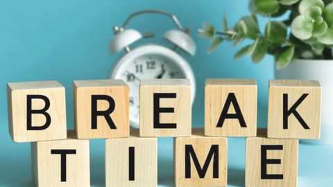 Video featuring a wooden block arrangement spelling \"BREAK TIME\" with black letters. Background includes a white clock and a potted plant with green leaves against a light blue wall.