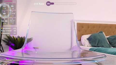 Video of a modern bedroom with a transparent, curved chair, teal pillows, and a beige headboard against a white wall. A digital overlay shows stats like \"Crii Kite\" with 30% health.
