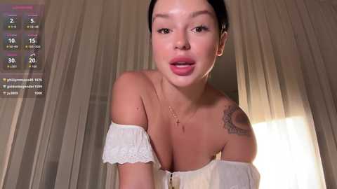A video of an East Asian woman with fair skin, black hair, and a medium build, wearing an off-shoulder white dress, leaning forward with a slightly open mouth.